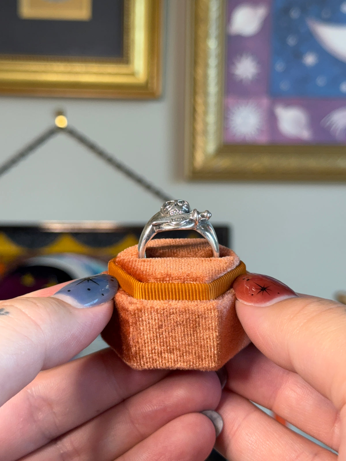 Skull biting dagger ring