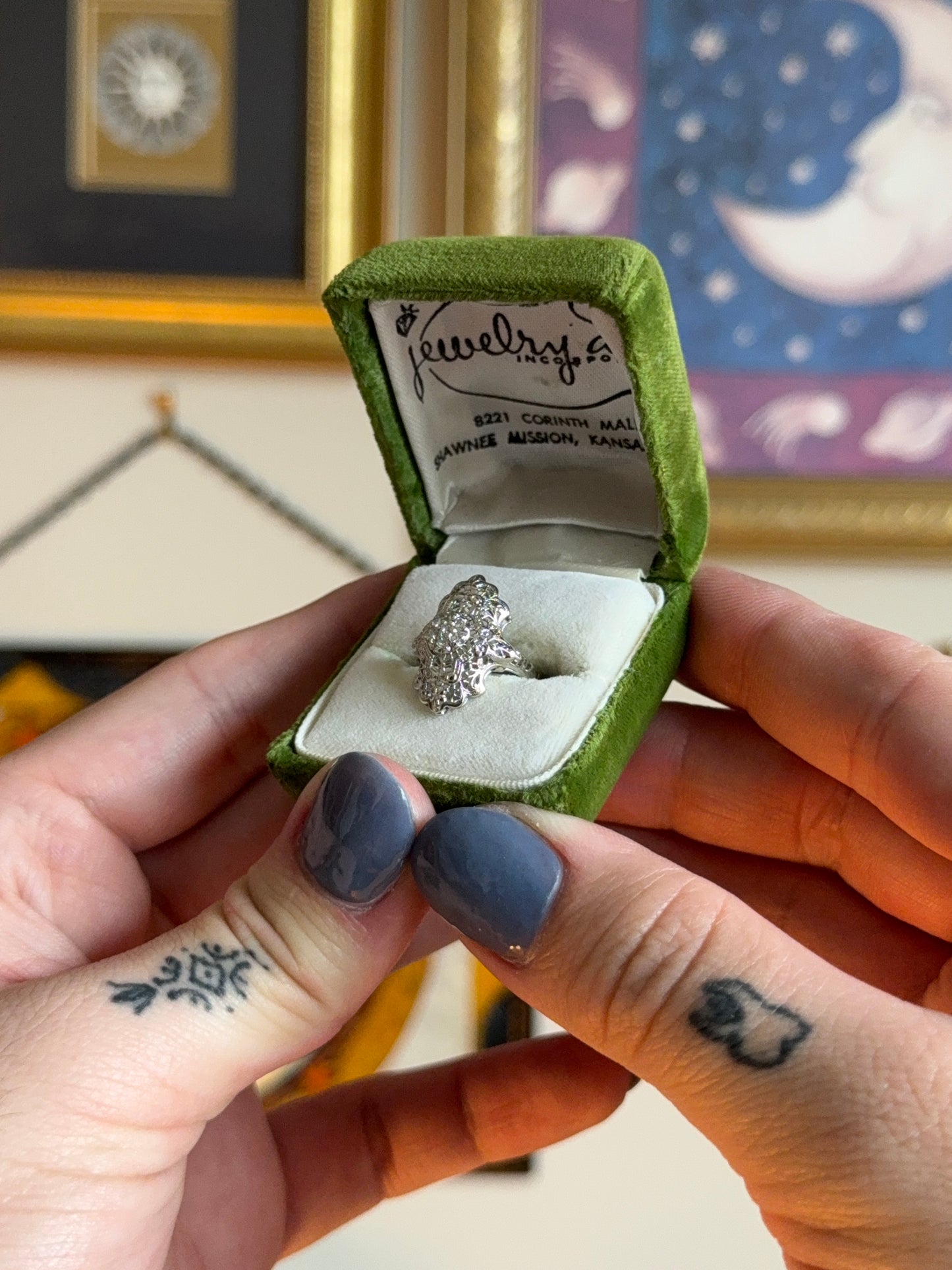 Antique shield ring with ornate filigree and diamond cluster.