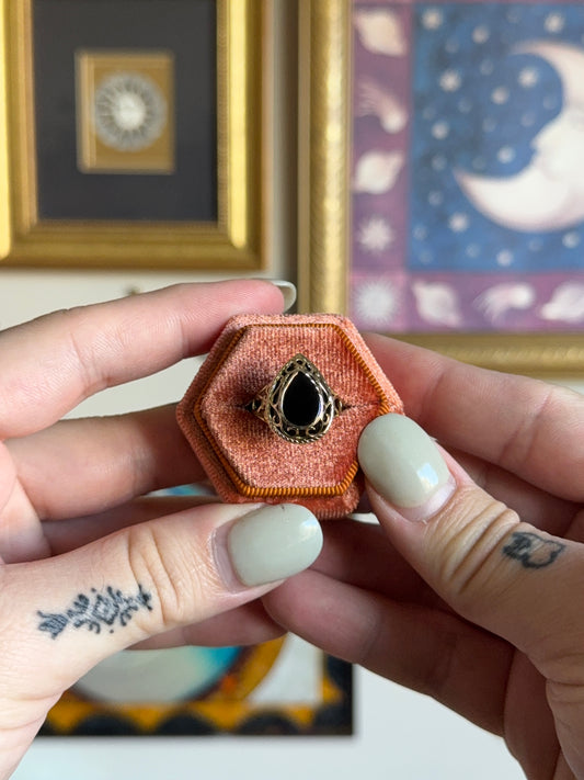 Pear shaped black onyx with filigree gold