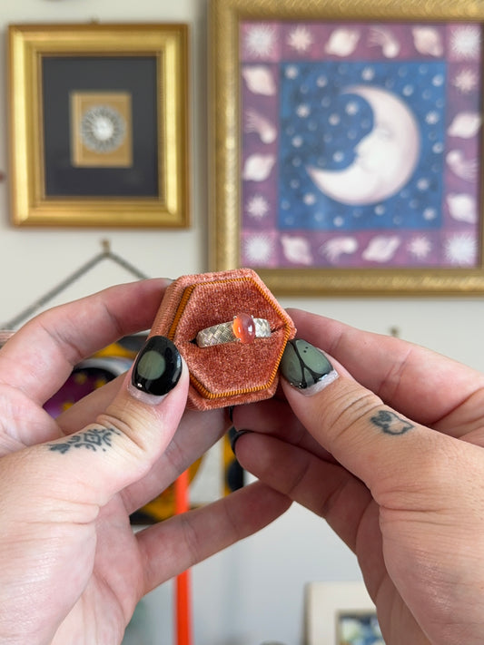 Orange cabochon star sapphire ring