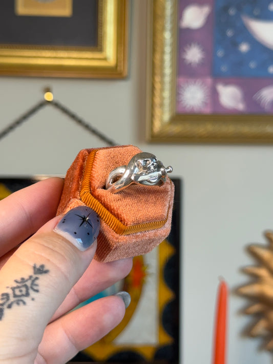 Skull biting dagger ring