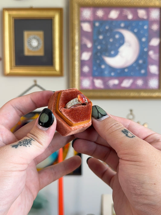 Orange cabochon star sapphire ring