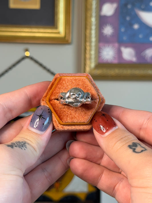 Skull biting dagger ring